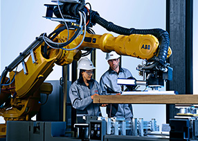 ABB employees working with wood milling robot (photo)