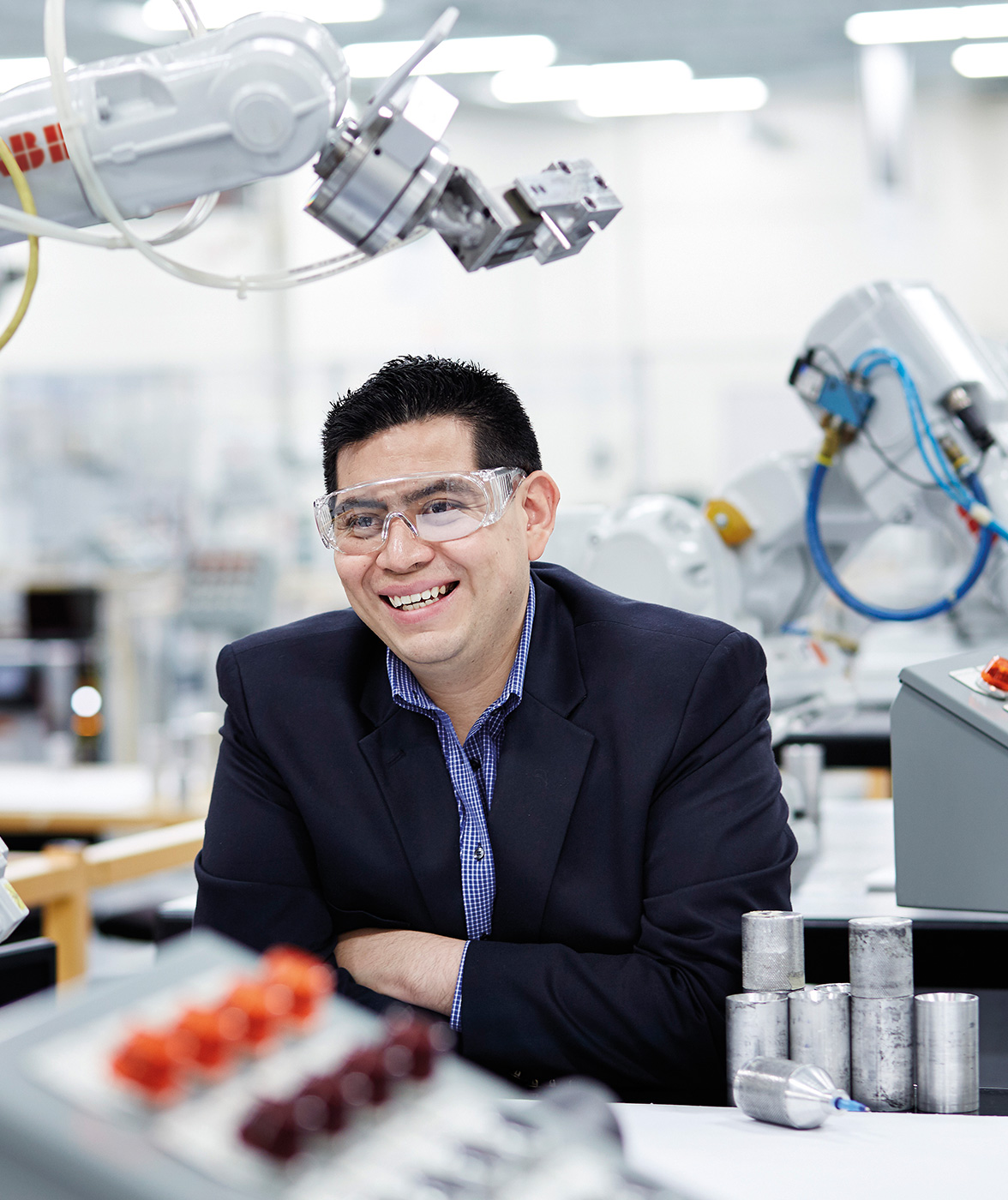 ABB employee with protective glasses smiling (photo)