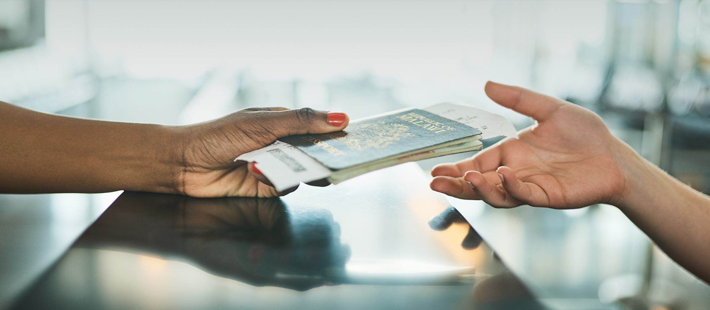 Woman handing over her passport (photo)