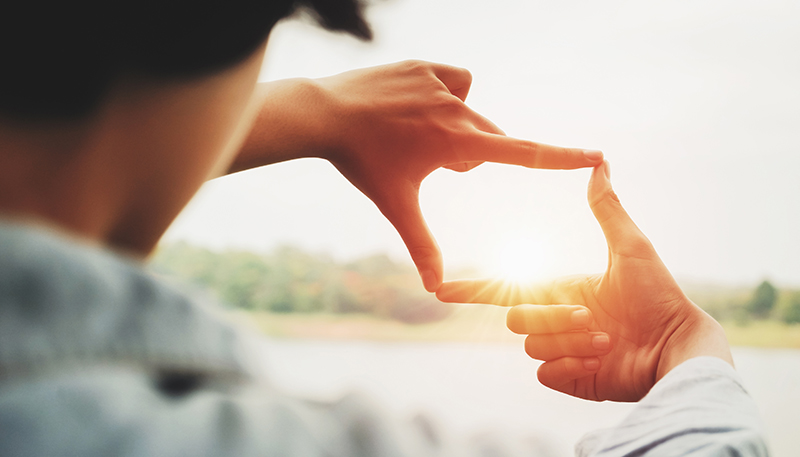 Looking at the sunlight through hands "we see light rising” (photo)