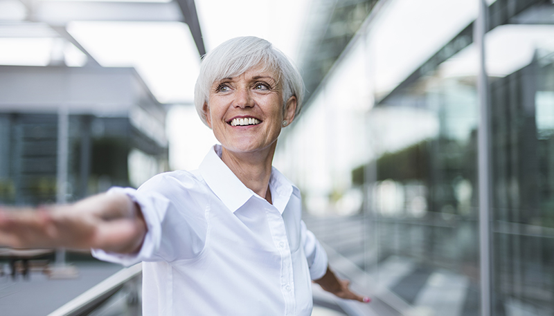 Woman stretching her arms and smiling (photo)