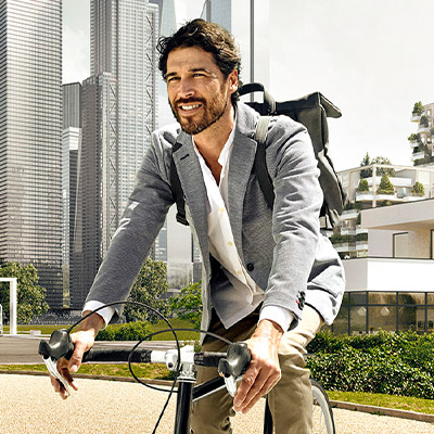 Man on a bicycle in a smart and sustainable city (photo)